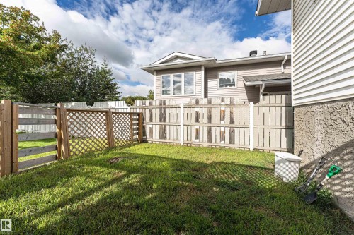Fenced backyard area featuring a grass lawn and a wood lattice fence - 4521 29 Avenue Nw, Edmonton, AB - Outdoor