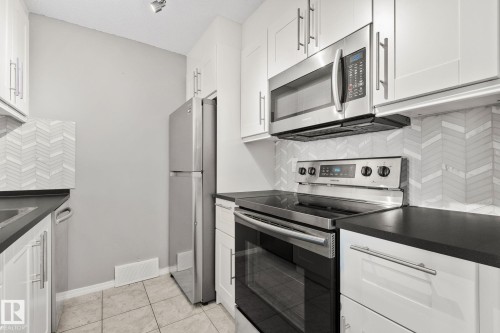 #210 2508 50 St Nw, Edmonton, AB - Indoor Photo Showing Kitchen With Stainless Steel Kitchen