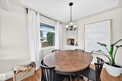 Recessed wall niche, wood-finish flooring, and a modern chandelier - 