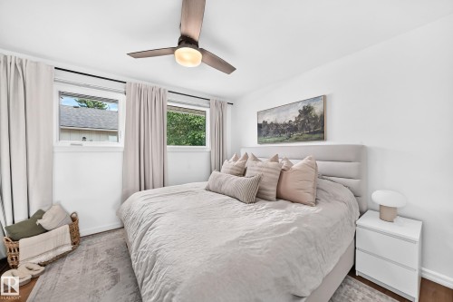 Recessed lighting, wood-finish flooring, two large windows, white walls, and a ceiling fan with integrated lighting - 16406 87A Avenue Nw, Edmonton, AB - Indoor Photo Showing Bedroom