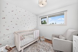 Bright room featuring a large window, a decorative wall, a flush-mount ceiling light, and wood-finish flooring - 