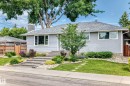 Gray horizontal siding exterior with a shingle roof and a stone chimney - 16406 87A Avenue Nw, Edmonton, AB  - Outdoor 