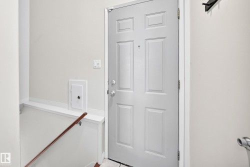 Panel-style entry door with chrome hardware - 16406 87A Avenue Nw, Edmonton, AB - Indoor Photo Showing Other Room