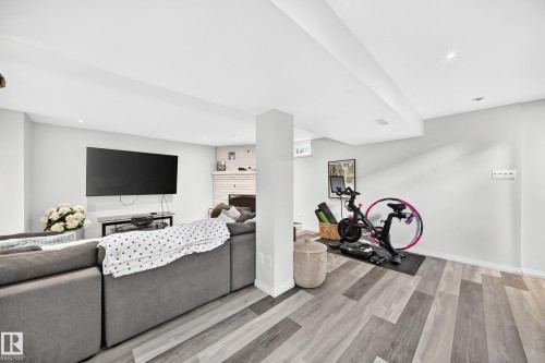Recessed lighting, wood-finish flooring, white painted walls, and a white brick fireplace - 16406 87A Avenue Nw, Edmonton, AB - Indoor
