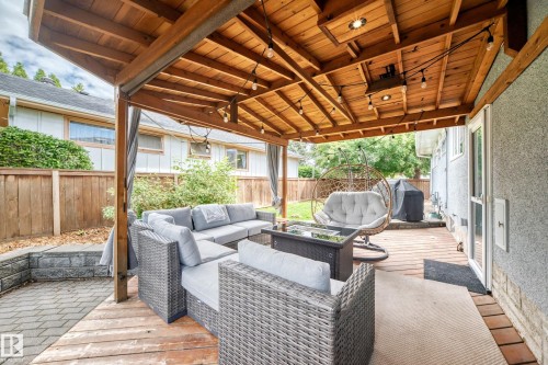 Covered outdoor living space featuring a wood-plank ceiling, recessed lighting, and string lights - 16406 87A Avenue Nw, Edmonton, AB - Outdoor With Deck Patio Veranda With Exterior