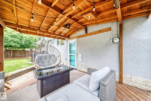 Covered patio featuring a wood-plank ceiling, exposed wood beams, and string lighting - 16406 87A Avenue Nw, Edmonton, AB -  With Deck Patio Veranda With Exterior