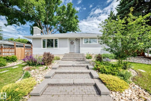 Light gray siding exterior with a dark gray shingled roof - 16406 87A Avenue Nw, Edmonton, AB - Outdoor