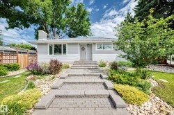 Light gray siding exterior with a dark gray shingled roof - 