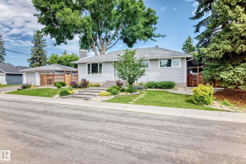 Light gray siding exterior with a shingled roof, concrete pathway leading to the entrance, an attached single-car garage, and established landscaping - 16406 87A Avenue Nw, Edmonton, AB - Outdoor