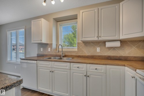 #1 5101 Soleil Bv, Beaumont, AB - Indoor Photo Showing Kitchen With Double Sink