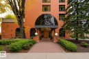 Brick exterior with arched entry, covered main entrance, and established landscaping - #2C 10050 118 St Nw, Edmonton, AB  - Outdoor 