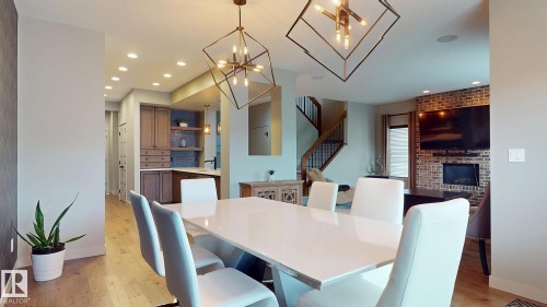223 Hawks Ridge Boulevard Nw, Edmonton, AB - Indoor Photo Showing Dining Room With Fireplace