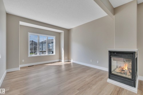 #23 5102 30 Av, Beaumont, AB - Indoor Photo Showing Living Room With Fireplace