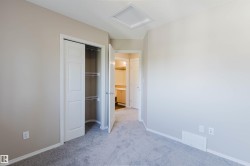Neutral-toned walls complement the gray carpeting - 