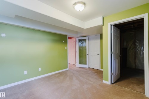 Carpeted flooring, recessed ceiling, flush mount lighting fixture, and paneled interior doors - 5887 Sutter Place Nw, Edmonton, AB - Indoor Photo Showing Other Room