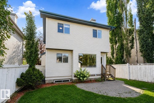 Two-story residence featuring light-colored siding and a contrasting dark roofline - 5887 Sutter Place Nw, Edmonton, AB - Outdoor