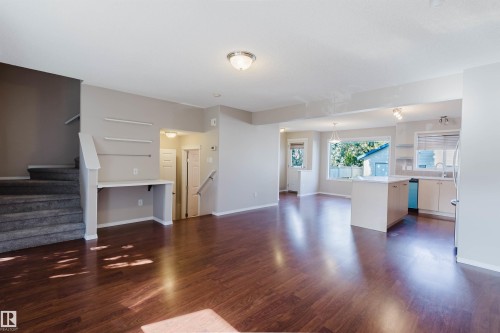 Wood-finish flooring throughout the main level - 5887 Sutter Place Nw, Edmonton, AB - Indoor