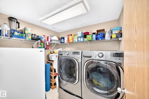 Large laundry room with storage on main floor. - #158 180 Bridgeport Bv, Leduc, AB - Indoor Photo Showing Laundry Room