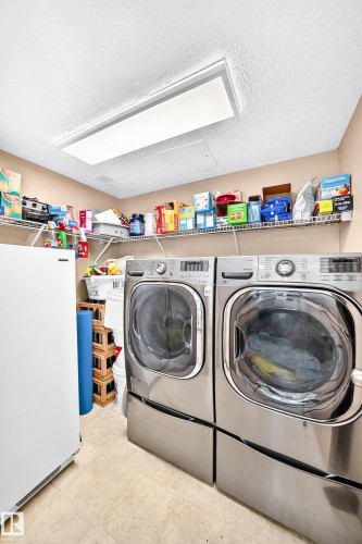 Large laundry room with storage on main floor. - #158 180 Bridgeport Bv, Leduc, AB - Indoor Photo Showing Laundry Room