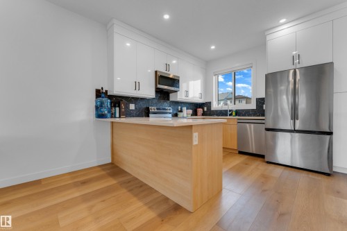 White cabinetry and stainless steel appliances - 3610 42 Avenue, Beaumont, AB - Indoor Photo Showing Kitchen