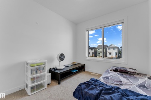 White painted walls with wall-to-wall carpeting and a large window - 3610 42 Avenue, Beaumont, AB - Indoor Photo Showing Bedroom