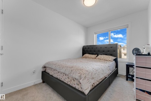 White walls with a window, carpeted flooring, and a ceiling light fixture - 3610 42 Avenue, Beaumont, AB - Indoor Photo Showing Bedroom