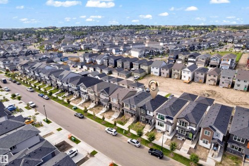 Contemporary residential neighborhood featuring a paved street and uniform rooflines - 3610 42 Avenue, Beaumont, AB - Outdoor With View