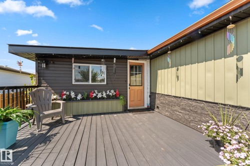 Expansive wooden deck with a built-in planter box - 5024 45A Street, Barrhead, AB - Outdoor With Deck Patio Veranda With Exterior