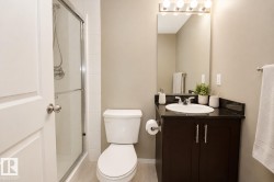 Walk-in shower with clear glass enclosure and chrome fixtures - 