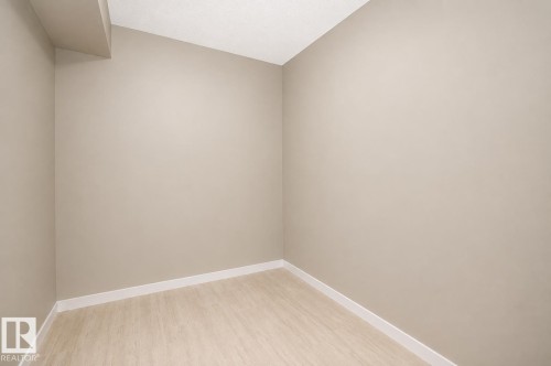 Recessed ceiling, neutral wall tones, white trim, and wood-finish flooring - #236 3315 James Mowatt Tr Sw, Edmonton, AB - Indoor Photo Showing Other Room