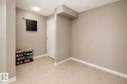 Light-toned tile flooring, neutral wall paint, white trim, and a flush-mount ceiling light fixture - 