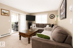 Sliding glass door to an outdoor area, wall-to-wall carpeting, and neutral wall tones - 