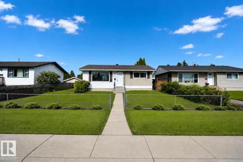 Single-story residence with a white and tan exterior, featuring a dark shingled roof - 12936 132 Street Nw, Edmonton, AB 