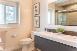 Dual vanity with integrated sinks, framed mirror, and mosaic tile backsplash - 