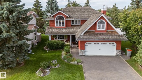 Red exterior siding with white trim, arched windows, and a shingled roof - 56 Highridge Way, Stony Plain, AB - Outdoor