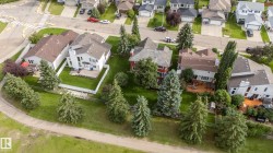 Residential property with a brown shingle roof, white siding, and a fenced yard - 