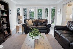 Hardwood flooring, crown molding, and large bay windows with patio door access - 