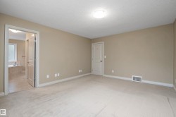 Carpeted room with neutral paint, baseboards, and a ceiling-mounted light fixture - 