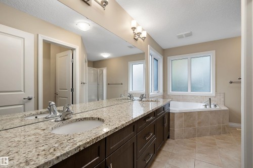 Dual vanity featuring granite countertops and undermount sinks - 11203 72 Avenue Nw, Edmonton, AB - Indoor Photo Showing Bathroom