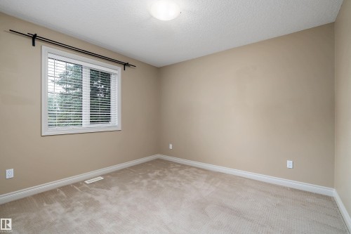 Neutral-toned wall paint with a window featuring white blinds and trim - 11203 72 Avenue Nw, Edmonton, AB - Indoor Photo Showing Other Room