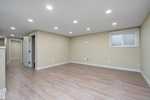 Spacious finished room featuring light wood-finish flooring, recessed lighting, and neutral wall tones - 11203 72 Avenue Nw, Edmonton, AB - Indoor