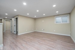 Spacious finished room featuring light wood-finish flooring, recessed lighting, and neutral wall tones - 