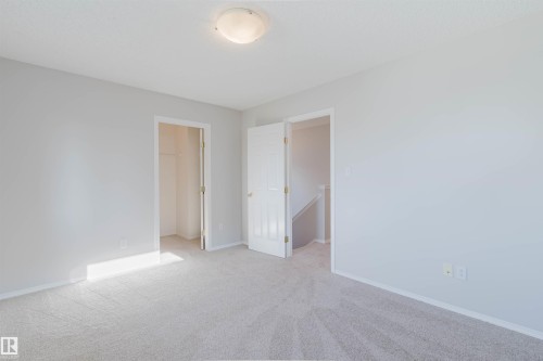 Light-toned carpeting, white walls, and a flush mount ceiling light fixture - 21332 89 Avenue Nw, Edmonton, AB - Indoor Photo Showing Other Room