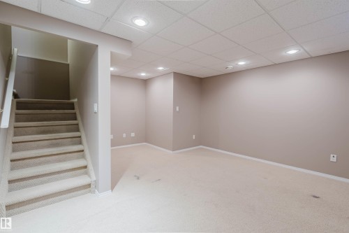 Finished lower level with neutral carpeting, recessed lighting, and a drop ceiling - 21332 89 Avenue Nw, Edmonton, AB - Indoor