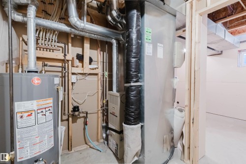 Water heater, furnace, and exposed ductwork - 21332 89 Avenue Nw, Edmonton, AB - Indoor Photo Showing Basement