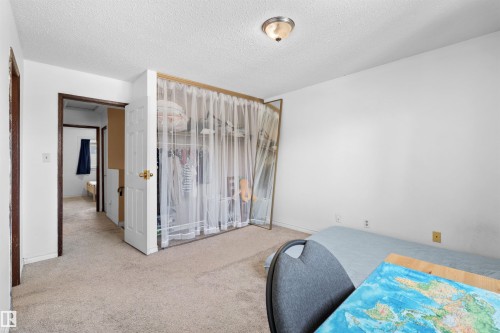 Wall-to-wall carpeting, overhead flush mount lighting, and a built-in closet with shelving - 2730 105 Street Nw, Edmonton, AB - Indoor Photo Showing Bedroom