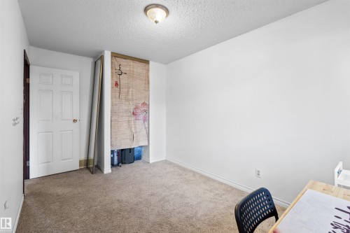 Carpeted flooring, white walls, and a paneled door - 2730 105 Street Nw, Edmonton, AB - Indoor