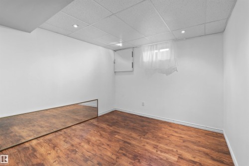 Wood-finish flooring with white walls and recessed lighting - 2730 105 Street Nw, Edmonton, AB - Indoor Photo Showing Other Room