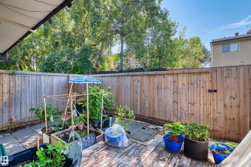 Private backyard space featuring a wooden deck, paved patio, and a wood privacy fence - 2730 105 Street Nw, Edmonton, AB - Outdoor With Deck Patio Veranda