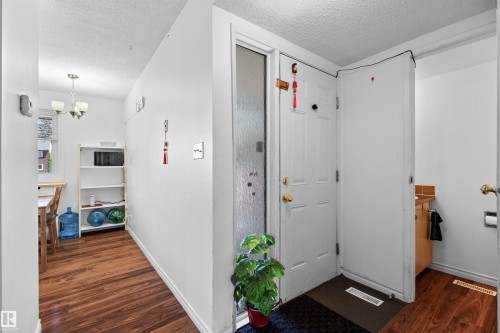 White entry door with frosted glass sidelight - 2730 105 Street Nw, Edmonton, AB - Indoor Photo Showing Other Room